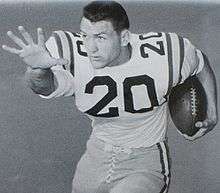 A football player wearing light colored uniform with the number 20 on it.