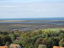 view of a river winding through open wetland