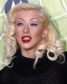 A young Caucasian female with blonde hair wearing red lipstick Right