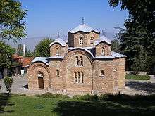 Exterior side view of the relatively small Church of St. Panteleimon showing the central windowed drum and dome as well as two of the four smaller windowed drums and domes built at the corners of the square plan
