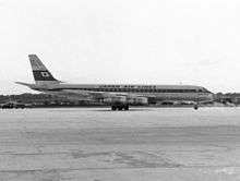 A black-and-white photograph of a Douglas DC-8 aircraft on the tarmac