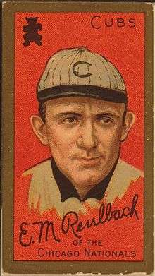Baseball card showing a head shot of a man facing forward wearing a white hat with a "C" on it. The card says "Cubs" in the upper right corner and says "Ed Reulbach of the Chicago Nationals" on the bottom.