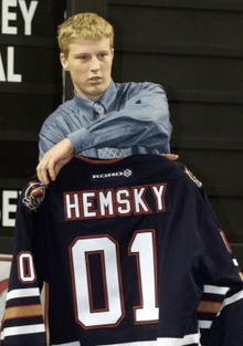 A Caucasian male shown from the waist up. He is holding a dark blue hockey jersey with the words Hemsky and the number 01 on the back.