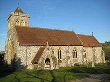 A side view of a church in the afternoon sunlight.