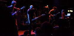 Four members of Isis onstage, playing their instruments