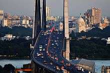 One of the many bridges in the city showing buses, taxis and other modes of road transport