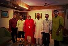 Six men standing behind icons