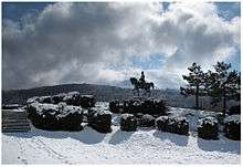 Photo of a statue of Napoleon overlooking a snow-covered scene