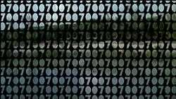 The outlines of row upon row of "007 007 007 007 007" fill the screen. A view of countryside, heavily obstructed can be seen in through the gaps.