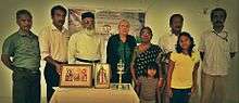 Group of people behind a table with icons