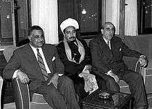 Three important fellows on a couch, two in suits