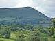In the distance, A barren mountain ridge top viewed from the east. The ridge falls away to the north.